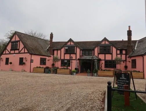 A large country pub with pink walls